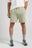 Persona che indossa Essential Sunwashed Sweatshorts in Seagrass, abbinati a calzini grigi e sneakers, in piedi su uno sfondo neutro | TP_IMAGE_TYPE=MODEL_FRONT