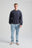 Persona che indossa una Essential Sweatshirt in Parisian Blue, abbinata a jeans azzurri e sneakers, per un look casual. | TP_IMAGE_TYPE=MODEL_FRONT