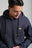 Personne portant un sweat à capuche zippé Organic Essential Zip Hoodie Trendsplant Blue avec un discret logo éléphant, vue de face | TP_IMAGE_TYPE=MODEL_FRONT