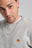 Persona che indossa una Organic Essential Sweatshirt in Heather Grey, con ricamo a forma di elefante; primo piano dello scollo e della zona del petto. | TP_IMAGE_TYPE=MODEL_FRONT
