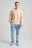 Persona che indossa una Essential Sunwashed Sweatshirt in Smoke Gray, abbinata a jeans azzurri e sneakers casual, in piedi su uno sfondo neutro. | TP_IMAGE_TYPE=MODEL_FRONT