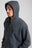 Personne portant un Essential Zip Hoodie en Bitumen Grey, avec capuche et fermeture à glissière frontale, vue en gros plan. | TP_IMAGE_TYPE=MODEL_FRONT