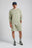 Personne portant le Essential Sunwashed Sweatshirt en coloris Seagrass, associé à un short et à des chaussures, debout dans un cadre neutre | TP_IMAGE_TYPE=MODEL_FRONT