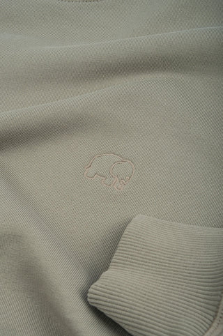 Close-up detail of the Dried Sage heavyweight oversized sweatshirt featuring an embroidered design | TP_IMAGE_TYPE=DETAIL