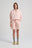Persona che indossa Women's Sunwashed Essential Quarter Zip Sweatshirt in Lotus Pink, abbinata a shorts coordinati e calze grigie. | TP_IMAGE_TYPE=MODEL_FRONT