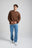Person wearing Essential Sweatshirt in Carafe Brown, paired with light blue jeans and white sneakers, standing in a neutral background | TP_IMAGE_TYPE=MODEL_FRONT