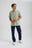 Person wearing an Essential Sunwashed Polo in Seagrass color, paired with dark denim pants, standing in a casual pose with a light background. | TP_IMAGE_TYPE=MODEL_FRONT