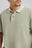 Person wearing an Essential Sunwashed Polo in Seagrass, showcasing the classic collar and embroidered detail | TP_IMAGE_TYPE=MODEL_FRONT