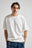 Personne portant un t-shirt oversize Essential Sunwashed Heavyweight en Foam White, vue de face | TP_IMAGE_TYPE=MODEL_FRONT
