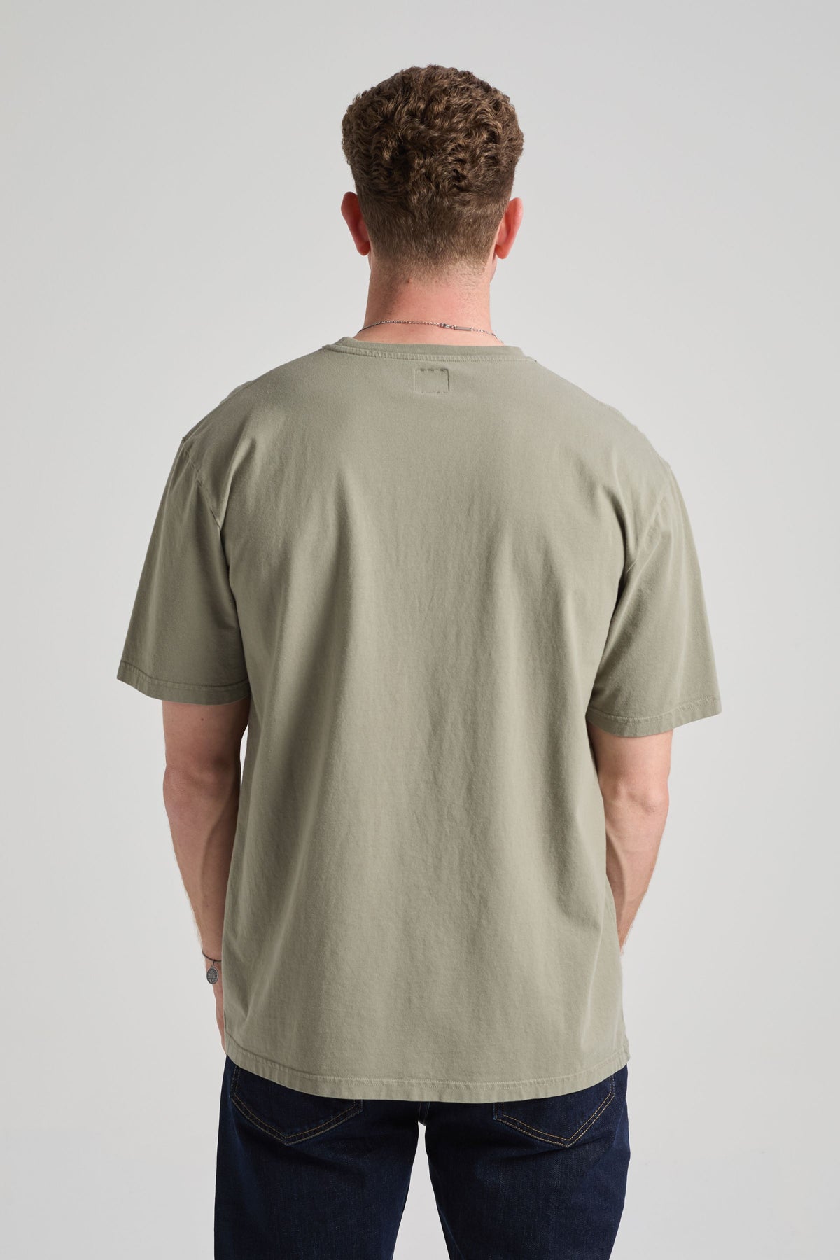 Person wearing an Agave Green Essential T-Shirt, back view | TP_IMAGE_TYPE=MODEL_BACK