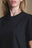 Persona che indossa una Women's Organic Essential T-Shirt in Black, vista frontale | TP_IMAGE_TYPE=MODEL_FRONT