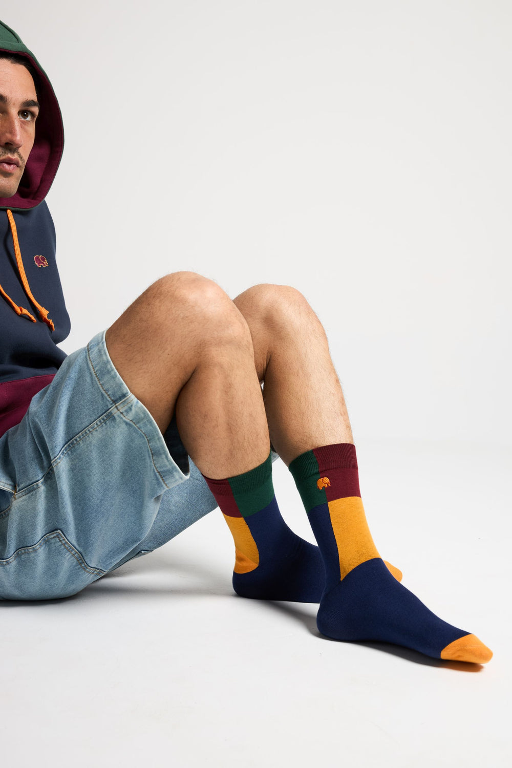 Person wearing Color Block Light Crew Socks Navy with colorful sections in green, burgundy, yellow, and navy | TP_IMAGE_TYPE=MODEL_FRONT