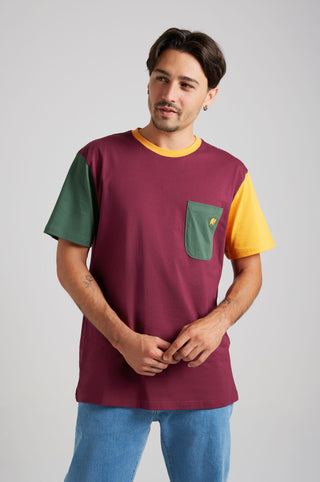Person wearing an Organic Pocket Color Block T-Shirt in Burgundy with green and yellow sleeves, posing casually against a neutral background. | TP_IMAGE_TYPE=MODEL_FRONT