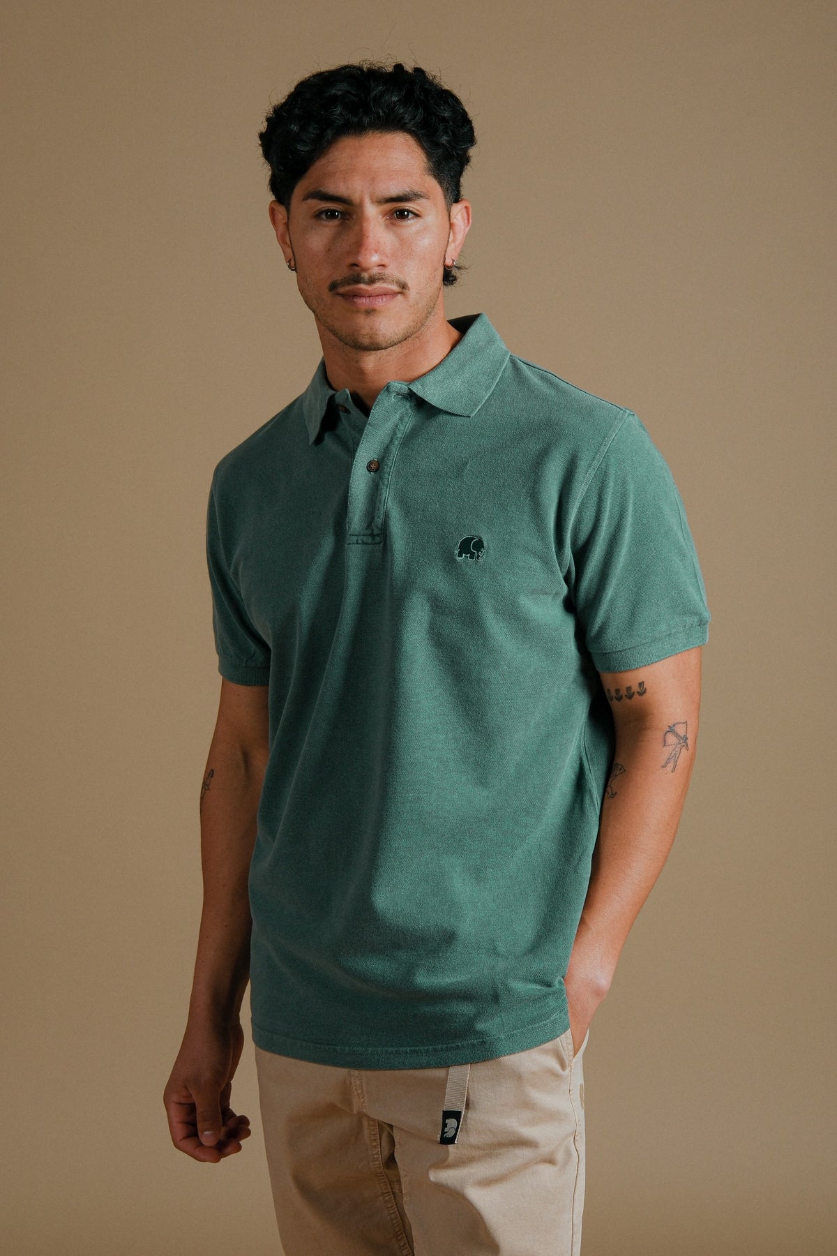 Person wearing an Organic Pigment Dyed Polo Shirt in Eden Green front view | TP_IMAGE_TYPE=MODEL_FRONT