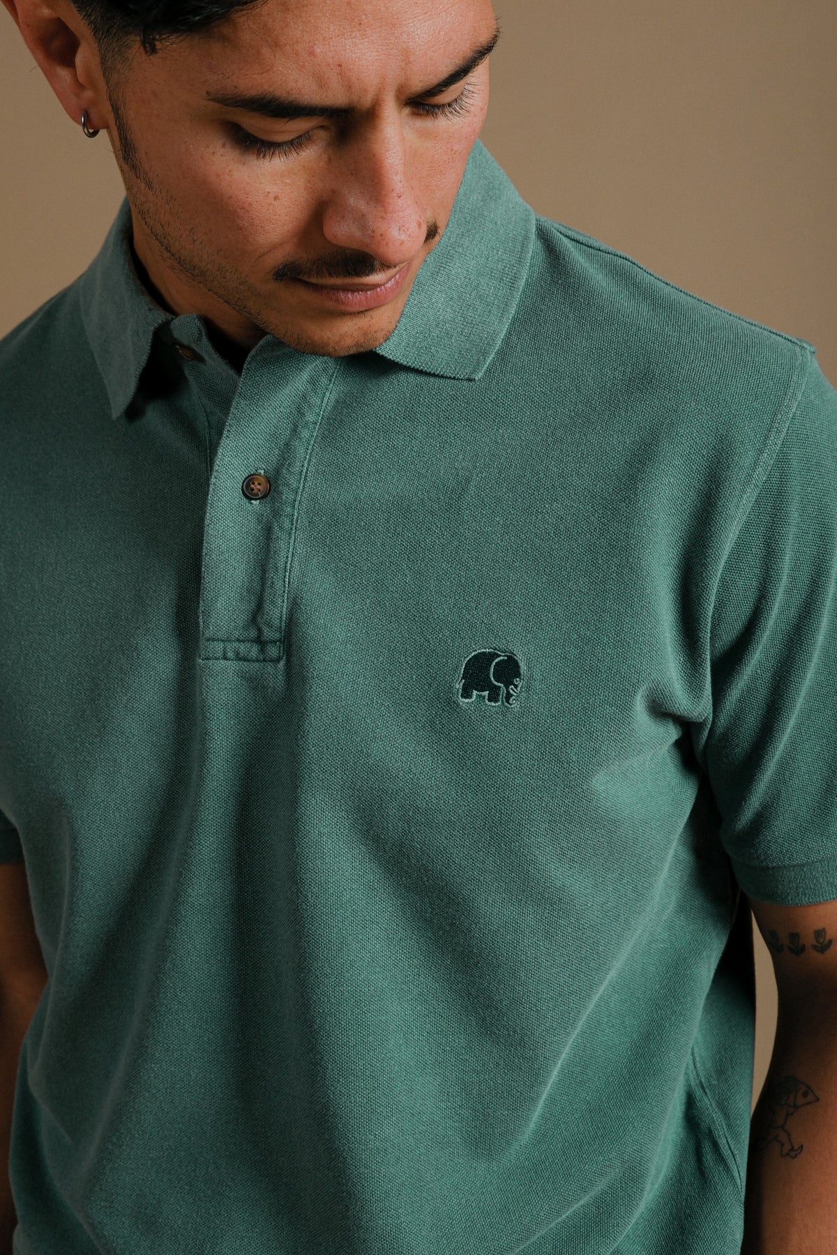 Person wearing an Organic Pigment Dyed Polo Shirt in Eden Green, front view | TP_IMAGE_TYPE=MODEL_FRONT