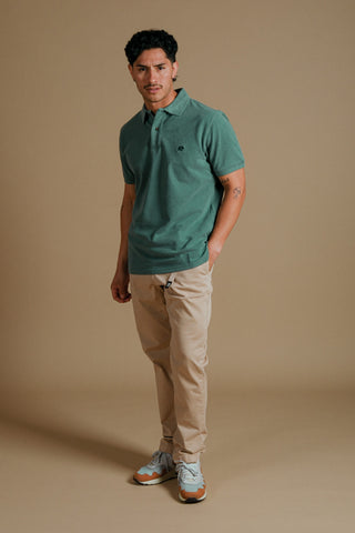 Person wearing an Organic Pigment Dyed Polo Shirt in Eden Green front view | TP_IMAGE_TYPE=MODEL_FRONT