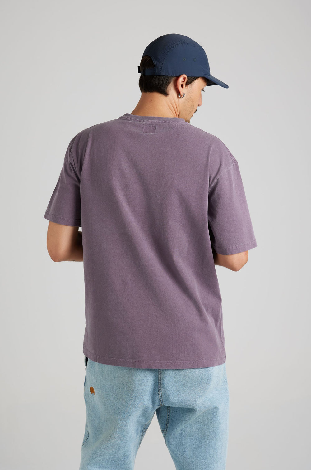Persona che indossa una Garza Pigment Dyed T-Shirt in Sunset Purple, vista da dietro con un outfit casual. | TP_IMAGE_TYPE=MODEL_BACK