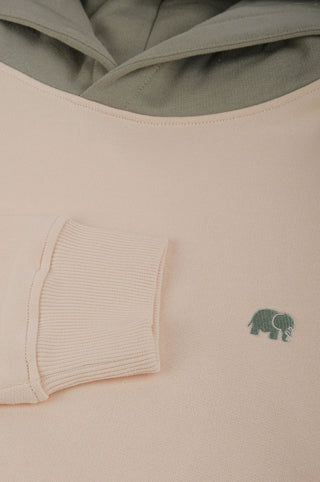 Close-up detail of Color Block Hoodie in Pale Glow showing the soft fabric and green elephant logo | TP_IMAGE_TYPE=DETAIL