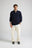 Personne portant le Bernia Quarter Zip Knit en Ocean Blue, avec un pantalon clair et des baskets. | TP_IMAGE_TYPE=MODEL_FRONT