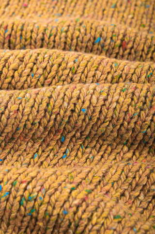 Close-up detail of the textured knit pattern of the Maigmo Knit Dijon, showcasing its vibrant hues and color flecks. | TP_IMAGE_TYPE=DETAIL