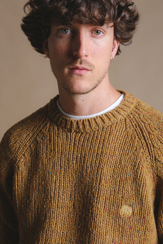 Person wearing Maigmo Knit Dijon sweater with a textured pattern featuring colorful specks | TP_IMAGE_TYPE=MODEL_FRONT