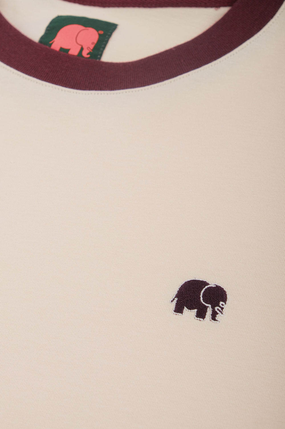 Close-up detail of Color Block T-Shirt in Pale Glow and Iron Veil featuring a small elephant logo | TP_IMAGE_TYPE=DETAIL