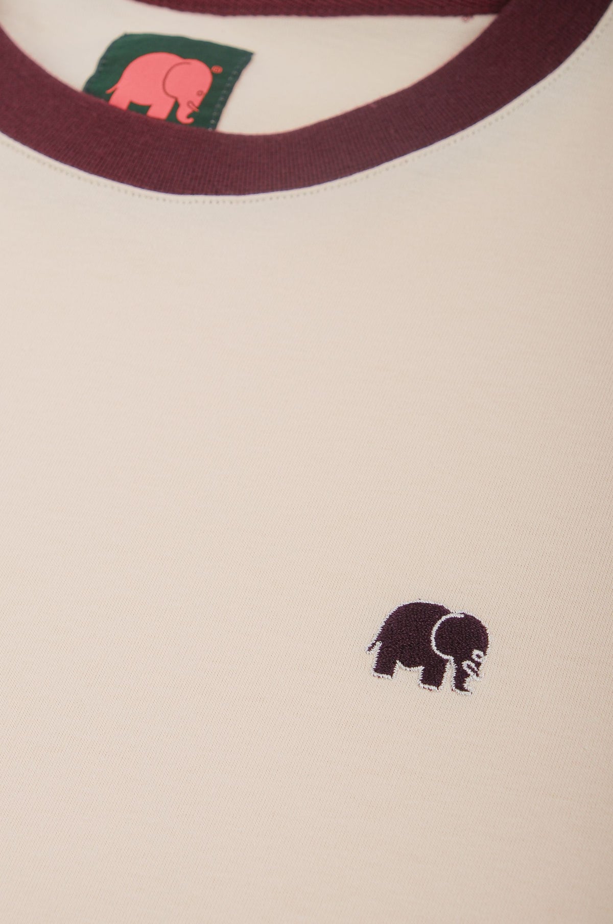 Close-up detail of Color Block T-Shirt in Pale Glow and Iron Veil featuring a small elephant logo | TP_IMAGE_TYPE=DETAIL