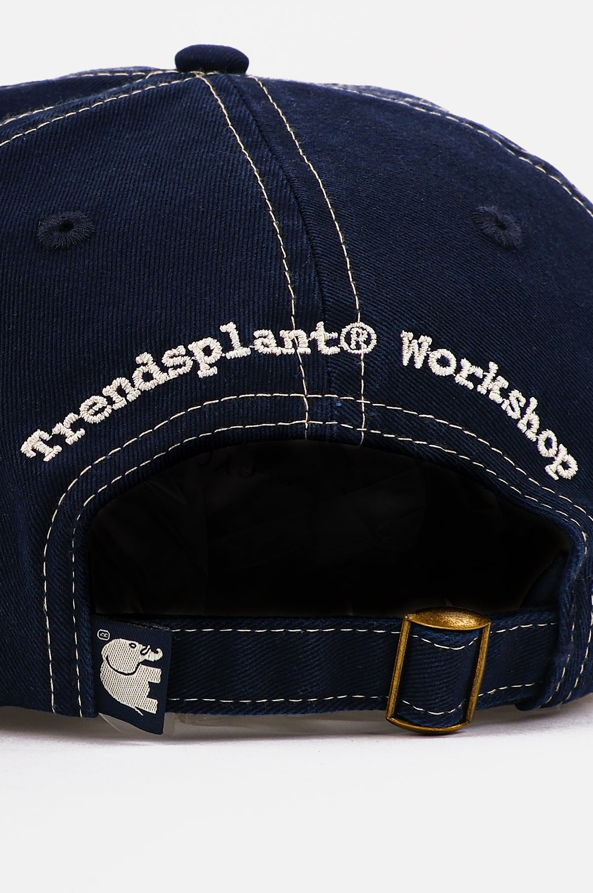 Detail view of the Dockyard Canvas Cap in Mood Indigo showcasing the embroidered logo and adjustable strap | TP_IMAGE_TYPE=DETAIL