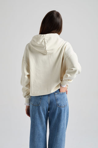 Persona che indossa una Women’s Crisantemo Hoodie in Antique White, vista di spalle, abbinata a denim casual. | TP_IMAGE_TYPE=MODEL_BACK