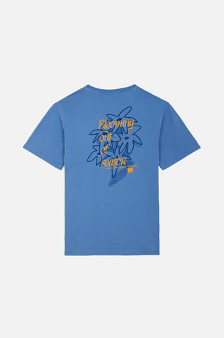 Bloom T-Shirt Ebb&Flow featuring a blue background with a floral design and text on the back | TP_IMAGE_TYPE=MODEL_BACK