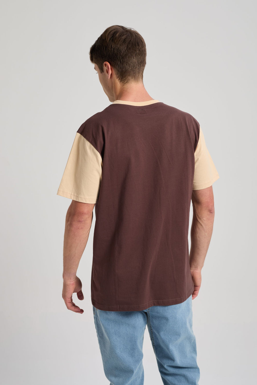 Person wearing a color block t-shirt featuring solemnity brown and cream colors, shown from the back | TP_IMAGE_TYPE=MODEL_BACK