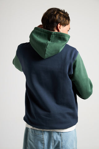 Persona che indossa la Organic Color Block Hoodie in blu e verde, vista posteriore | TP_IMAGE_TYPE=MODEL_BACK