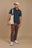 Personne portant une chemise polo Organic Essential Polo Shirt en bleu Trendsplant Blue, associée à un pantalon marron décontracté, debout avec assurance | TP_IMAGE_TYPE=MODEL_FRONT