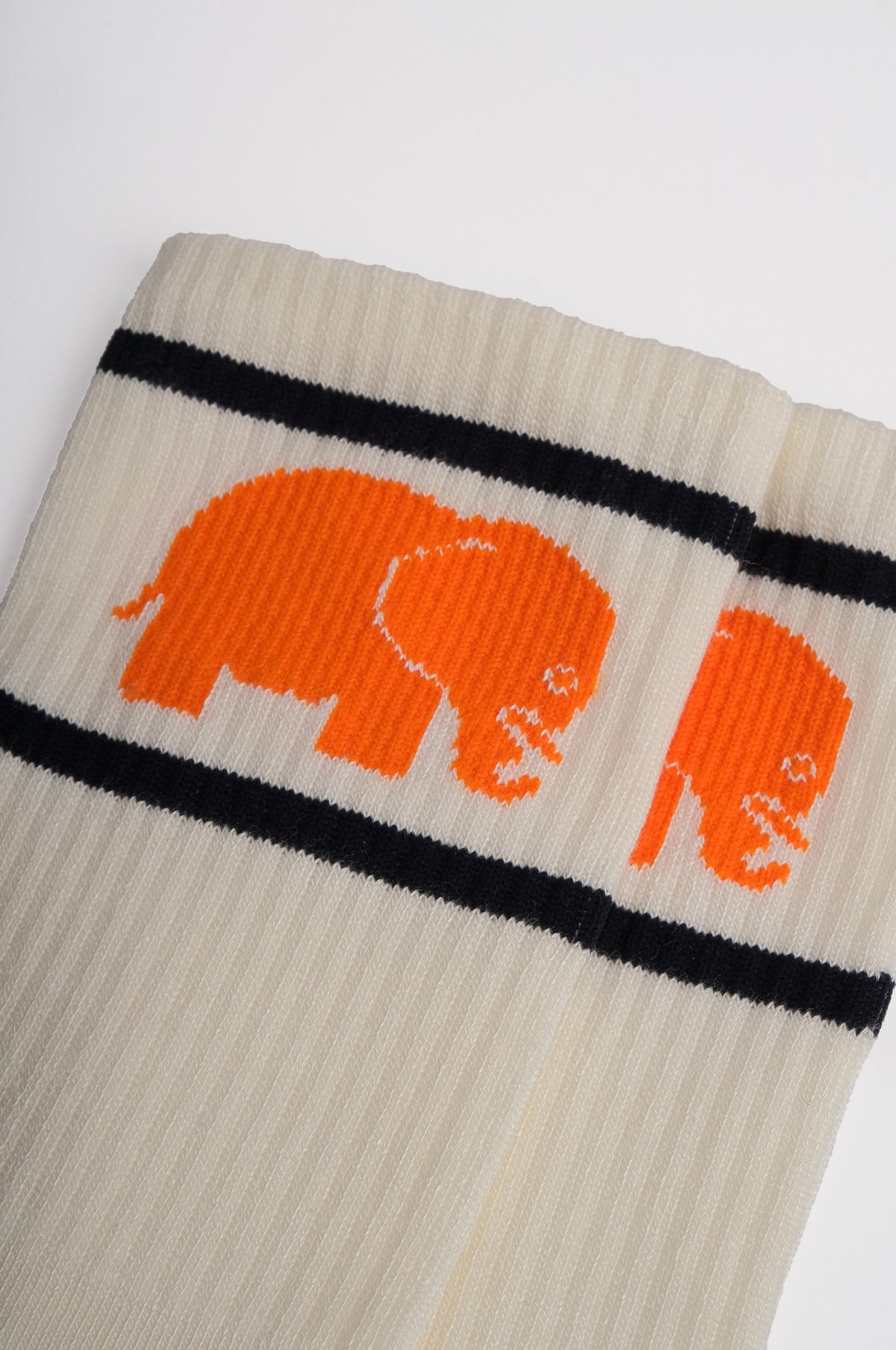 Détail en gros plan des chaussettes de sport en bambou naturel avec un motif d'éléphant orange sur fond crème | TP_IMAGE_TYPE=DETAIL