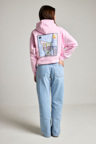 Personne portant le sweat à capuche oversize Women's Antonyo Marest x Trendsplant en Gum Pink, vue de dos avec un graphisme coloré dans le dos | TP_IMAGE_TYPE=MODEL_BACK