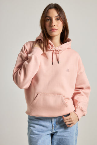 Personne portant un Women's Organic Essential Oversized Hoodie en Pale Pink, vue de face | TP_IMAGE_TYPE=MODEL_FRONT